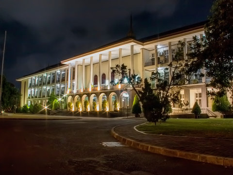 Outdoor Exterior UGM Central Building At Night. The First Modern Building Symbol Made in Indonesia - Gadjah Mada University.