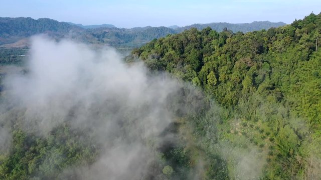 Aerial drone footage clouds over rainforest in Thailand 