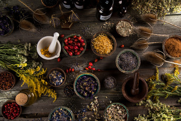Obraz na płótnie Canvas Herbs medicine and vintage wooden background
