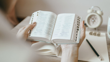 A woman reading the Bible in the morning