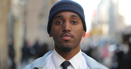 Young black man in cityserious face portrait 
