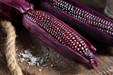 Boiled purple corn on wooden tray in rustic kitchen, Organic sweet purple corn
