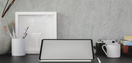 Cropped shot of modern office room with blank screen digital tablet and office supplies