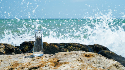 Glass bulb. Sea shore. Waves hit the stones.