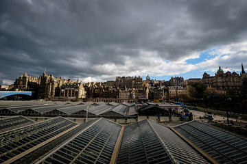 Fototapeta premium View of Edinburghs Market Street as seen from Waverly Station, with the stations glass ceiling in the foreground. Edinburgh, Scotland