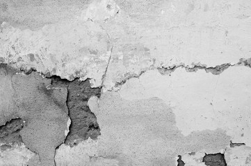Old cracked wall of an abandoned house close-up. Abstract background black and white