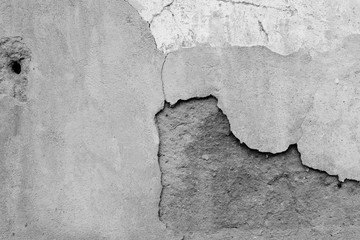 Old cracked wall of an abandoned house close-up. Abstract background black and white