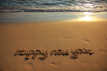 Happy New Year 2020 is coming concept on the sunset and tropical ocean beach lettering. 