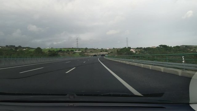 driving car on a freeway highway in cloudy day pov 4k