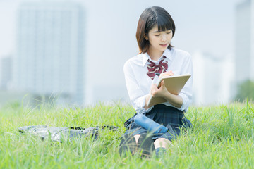 屋外で勉強する女子高生