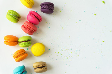 Obraz na płótnie Canvas Mixed of Colorful Macarons cake on white background with copy space. Sweet and colorful french macaroons on white background.