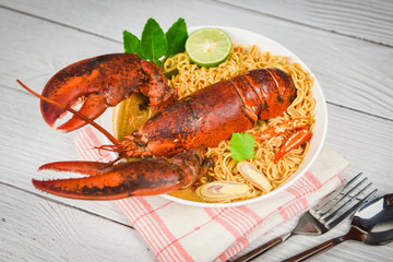 Noodles bowl lobster spicy soup / Cooked seafood with instant noodles soup lobster dinner table and spices ingredients on table thai food