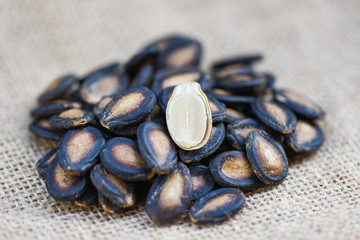 watermelon seeds on sack - close up dried watermelon seed with salt for food or snack