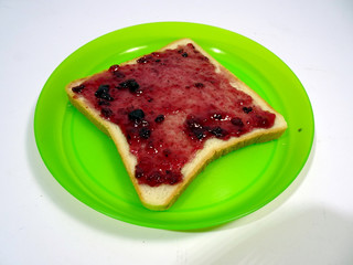 Blueberry jam spread on white sliced bread