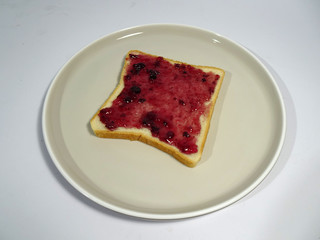 Blueberry jam spread on white sliced bread