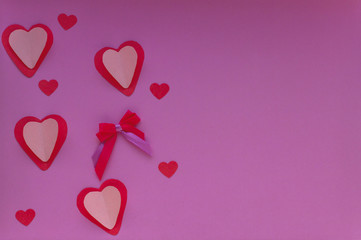 Hearts on the purple background. Valentin's Day, top view. Copy space. Flat lay, love