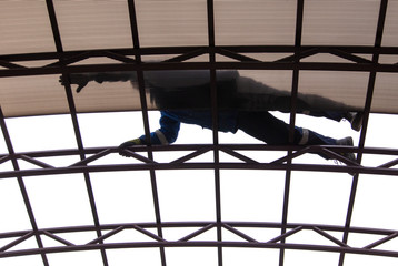 A worker mounts a metal canopy