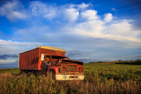 abandoned red truck on the field