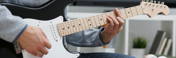 Male hands at home play and tun