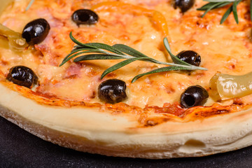 Tasty fresh hot pizza against a dark background. Pizza, food, vegetable, mushrooms.  It can be used as a background