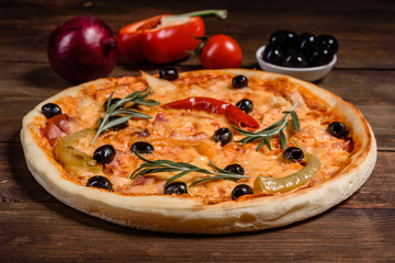 Tasty fresh hot pizza against a dark background. Pizza, food, vegetable, mushrooms.  It can be used as a background