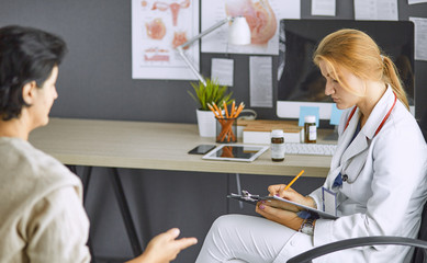 young woman doctor takes patient in office