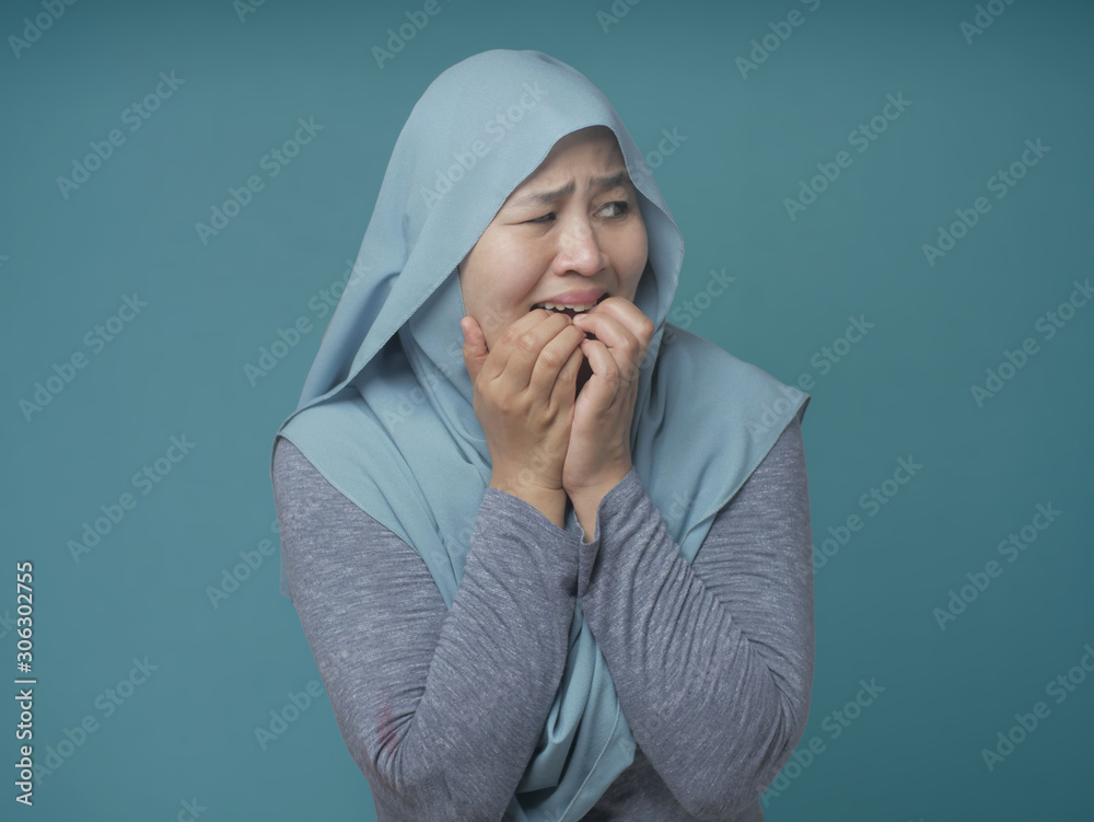 Wall mural Worried Muslim Woman Biting Nails