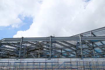 The structure of building with blue sky and cloud as a background, Steel construction in large construction site, Space for text in template