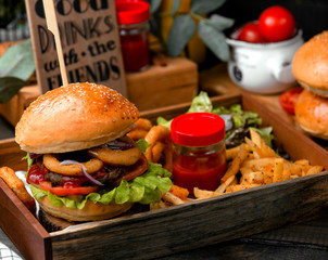 burger with onion rings in batter and french fries