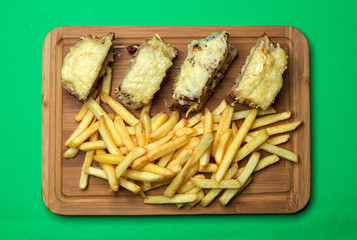 grated cheese on black bread and french fries