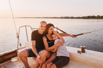 Happy family sailing on a luxury yacht or catamaran boat