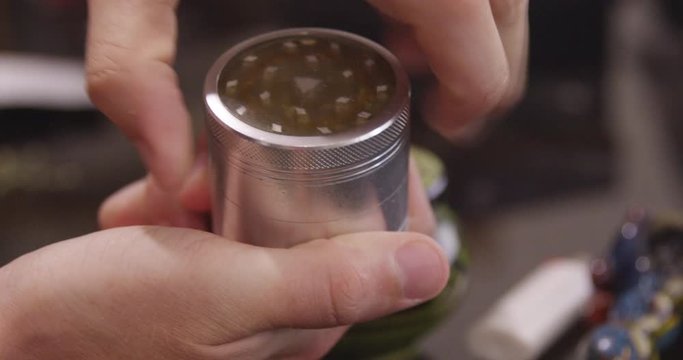 Close Up - A cannabis grinder is unscrewed to reveal the tray and herb inside - shot on RED
