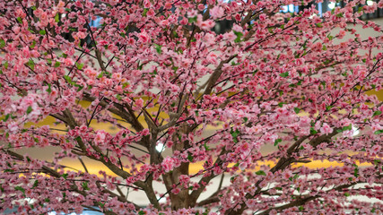 Pink cherry blossom flowers made from plastic.