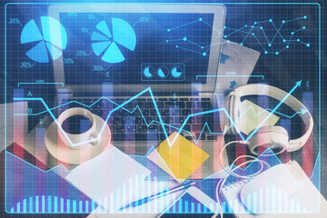 Double exposure of chart and financial info and work space with computer background. Concept of international online trading.