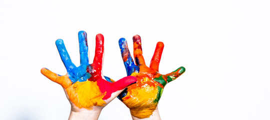 Hands of a child in paint on a white background.