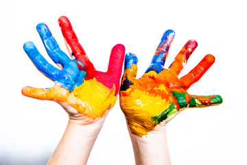 Hands of a child in paint on a white background.