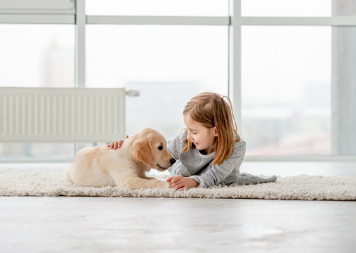 Little girl with young dog
