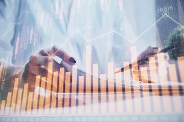 Financial chart drawn over hands taking notes background. Concept of research. Multi exposure