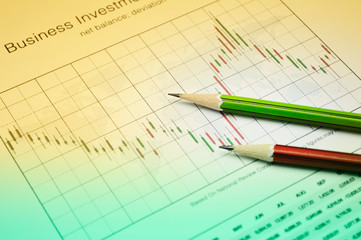 Pencil on stock market graph, Business investment concept