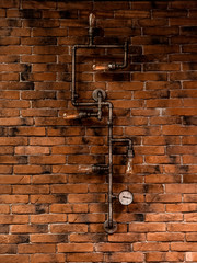 electric pipes with a brush on a brick wall