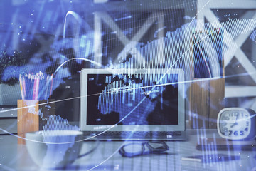 Financial graph colorful drawing and table with computer on background. Double exposure. Concept of international markets.