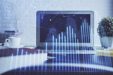 Forex market chart hologram and personal computer background. Double exposure. Concept of investment.