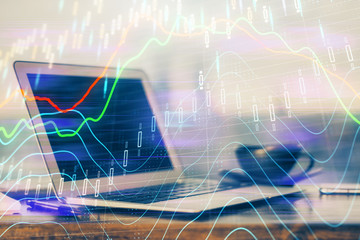 Stock market graph and table with computer background. Multi exposure. Concept of financial analysis.