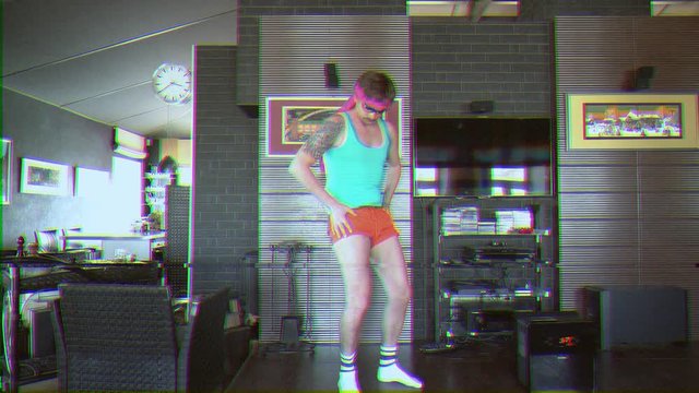 Funny young man dressed in 80s style does aerobic exercises. VHS Effect with noise. He is dressed in short shorts and a tight shirt. Funny freak.