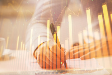 Financial trading chart multi exposure with man desktop background.