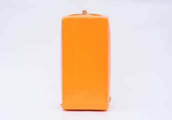 Big cheese head in yellow vacuum package. Cheese block isolated on white background with clipping Path included.