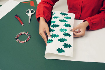 Female hands making a box rabbit. Holiday Easter light. Material for creative.
