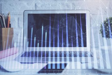 Forex Chart hologram on table with computer background. Multi exposure. Concept of financial markets.