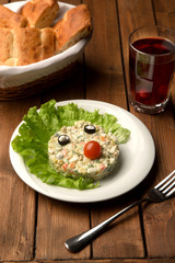 capital salad with olive eyes and tomato nose