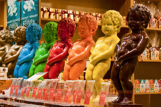 Manneken Pis, Little Pissing Man colorful chocolate statues at candy shop window display. Brussels, Belgium - March 12, 2012